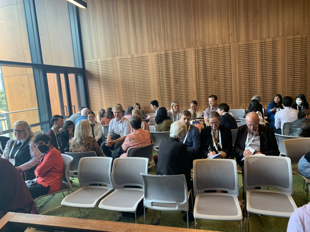 Delegates seated in small groups in conversation during the generalism workshop at WONCA Sydney 2023